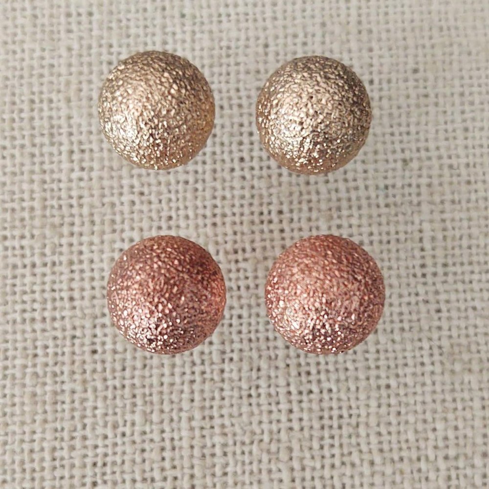 2 pairs of textured gold and pale copper stud earrings